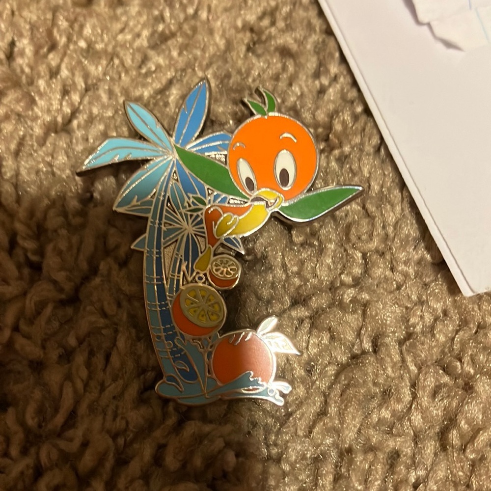 orange bird with palm tree pin